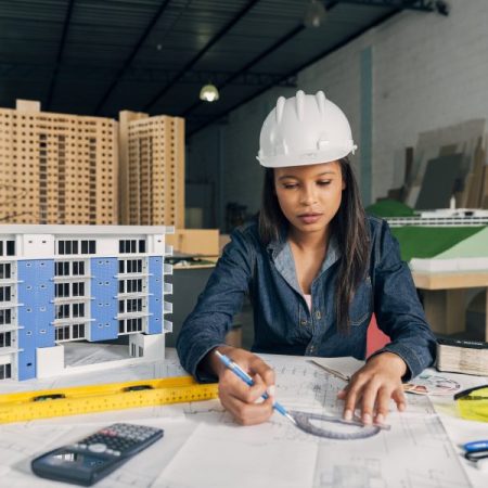 african-american-lady-safety-helmet-working-near-model-building