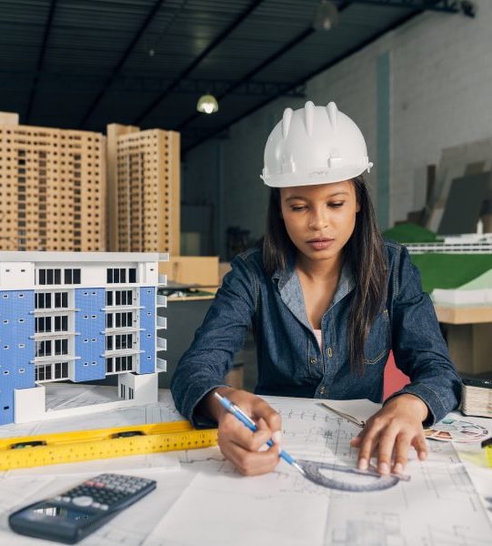 african-american-lady-safety-helmet-working-near-model-building